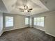 Spacious main bedroom with three windows and a ceiling fan at 2578 Lavender Ct, Decatur, GA 30034