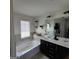 Bright bathroom featuring a double sink vanity, soaking tub, and updated fixtures at 3168 Spicy Cedar Ln, Lithonia, GA 30038