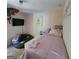 Cozy bedroom with pink accents, a beanbag chair, and a wall-mounted TV at 3168 Spicy Cedar Ln, Lithonia, GA 30038