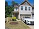 Charming brick townhome with a well-manicured lawn and attached garage at 3168 Spicy Cedar Ln, Lithonia, GA 30038