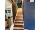 Staircase featuring wooden treads and white risers with dark accent wall at 3168 Spicy Cedar Ln, Lithonia, GA 30038