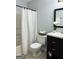 Bright bathroom with a shower/tub combo, and a dark vanity with ample storage at 7665 Antebellum Ln, Riverdale, GA 30274