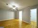 A spacious bedroom with a ceiling fan, closet, and attached bathroom entrance at 7665 Antebellum Ln, Riverdale, GA 30274