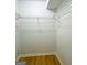 Walk-in closet with wood floors and shelf space at 7665 Antebellum Ln, Riverdale, GA 30274