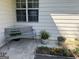 Exterior patio with bench and flower pots adjacent to window; perfect relaxing space at 7665 Antebellum Ln, Riverdale, GA 30274