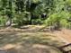 A spacious and level backyard surrounded by mature trees at 1815 Dodson Sw Dr, Atlanta, GA 30311