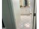 Bright bathroom with white tile flooring and a granite countertop vanity at 1815 Dodson Sw Dr, Atlanta, GA 30311