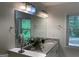 Bathroom features a granite countertop, dual sinks and natural light from a window at 1815 Dodson Sw Dr, Atlanta, GA 30311