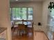 Cozy dining area with a round table, seating for four, and a large window with a backyard view at 1815 Dodson Sw Dr, Atlanta, GA 30311