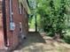 Exterior view of red brick home, showing side yard access at 1815 Dodson Sw Dr, Atlanta, GA 30311