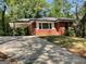 Charming one-story brick house with a carport and well-maintained front yard, nestled among mature trees at 1815 Dodson Sw Dr, Atlanta, GA 30311