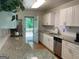 Open kitchen with white cabinets, granite countertops, and a view to the backyard deck at 1815 Dodson Sw Dr, Atlanta, GA 30311