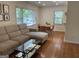 Spacious living room featuring hardwood floors, large windows, and seamless transition to the dining area at 1815 Dodson Sw Dr, Atlanta, GA 30311