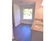 Bathroom with a double sink vanity, granite countertop, and a large window at 11755 Highway 36, Covington, GA 30014