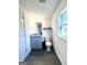 A bathroom featuring a modern vanity with granite countertops and gray cabinets at 11755 Highway 36, Covington, GA 30014