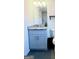 A bathroom featuring a modern vanity with granite countertops and gray cabinets at 11755 Highway 36, Covington, GA 30014