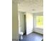 Bright bathroom with a toilet and a window overlooking an outdoor view at 11755 Highway 36, Covington, GA 30014