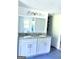 Bathroom featuring a double vanity with a large mirror and soft gray cabinetry at 11755 Highway 36, Covington, GA 30014