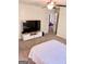 Well-lit bedroom with a large TV and a white TV stand, providing entertainment at 11755 Highway 36, Covington, GA 30014
