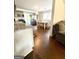 Open concept dining area with hardwood floors and modern kitchen in the background at 11755 Highway 36, Covington, GA 30014