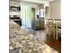 Bright eat-in kitchen with stainless steel appliances, gray cabinets and a white dining set at 11755 Highway 36, Covington, GA 30014
