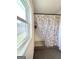 Shower featuring white subway tile, a window and a patterned shower curtain at 11755 Highway 36, Covington, GA 30014