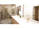 Modern bathroom features a double vanity, sleek mirrors, and a glass enclosed shower at 185 Wadley Nw St, Atlanta, GA 30314
