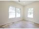 Bright empty bedroom with two windows and light wood flooring at 185 Wadley Nw St, Atlanta, GA 30314