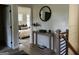 Bright entryway features a console table with a round mirror and a glimpse of the bedroom at 185 Wadley Nw St, Atlanta, GA 30314