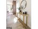 Inviting entryway featuring stylish decor, a round mirror, and a view into the bright living space at 185 Wadley Nw St, Atlanta, GA 30314