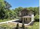 Two-story home with a covered porch, long driveway, and landscaped front yard at 185 Wadley Nw St, Atlanta, GA 30314