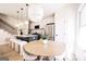 Stylish kitchen with white cabinets, stainless appliances, island seating, and adjacent dining area at 185 Wadley Nw St, Atlanta, GA 30314