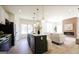 Bright kitchen with island, stainless steel appliances, and pendant lighting open to the living room at 185 Wadley Nw St, Atlanta, GA 30314