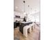 Bright, modern kitchen featuring an island with stool seating and stylish pendant lighting at 185 Wadley Nw St, Atlanta, GA 30314