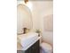 Modern powder room with a sleek vanity, vessel sink, designer faucet and stylish mirror at 185 Wadley Nw St, Atlanta, GA 30314