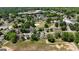 An aerial view shows the neighborhood's charming homes and tree-lined streets, near a park and historic buildings at 30 Poplar St, Porterdale, GA 30014