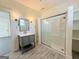 Contemporary bathroom features a modern vanity, a glass-enclosed shower, and decorative wainscotting at 30 Poplar St, Porterdale, GA 30014