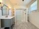 Well-lit bathroom with a glass-enclosed shower, single vanity, and wainscoting at 30 Poplar St, Porterdale, GA 30014