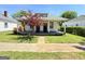 Charming single story home with a covered front porch and a small decorative tree in the front yard at 30 Poplar St, Porterdale, GA 30014