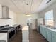 Spacious kitchen with stainless steel appliances, an island, and decorative tin ceiling at 30 Poplar St, Porterdale, GA 30014