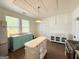 Eat-in kitchen with an island, stainless steel appliances, vintage ceiling and a classic color scheme at 30 Poplar St, Porterdale, GA 30014