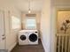 Bright laundry room with included washer and dryer and white cabinets at 30 Poplar St, Porterdale, GA 30014