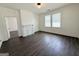 This open living area features natural light, a fireplace, and hardwood floors at 30 Poplar St, Porterdale, GA 30014
