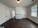 Bright living room featuring dark wood-look floors, white trim and a decorative fireplace at 30 Poplar St, Porterdale, GA 30014