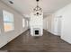 Open living room with wood floors, a fireplace, and natural light at 30 Poplar St, Porterdale, GA 30014