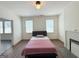 Bright main bedroom features hardwood floors, natural light and a non-working fireplace at 30 Poplar St, Porterdale, GA 30014