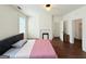 Cozy main bedroom with a decorative fireplace, hardwood floors, and natural light at 30 Poplar St, Porterdale, GA 30014