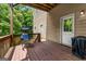 Spacious wooden back deck with wood railing overlooking the greenery and a blue lounge chair at 803 Baugh Springs Ln, Lawrenceville, GA 30044