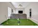 Finished basement includes a custom indoor putting green, sectional seating, and large television at 803 Baugh Springs Ln, Lawrenceville, GA 30044