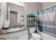 Cozy bathroom with granite countertops, white cabinets, and a shower with a patterned curtain at 803 Baugh Springs Ln, Lawrenceville, GA 30044